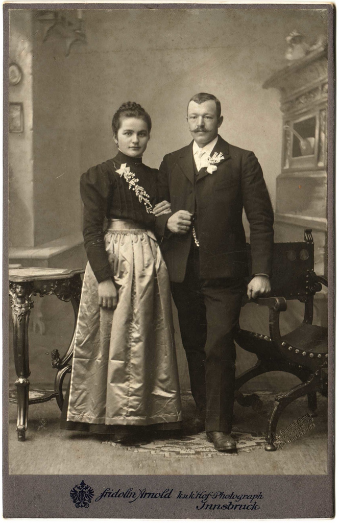1890s couple, the woman in a creased silk satin skirt
