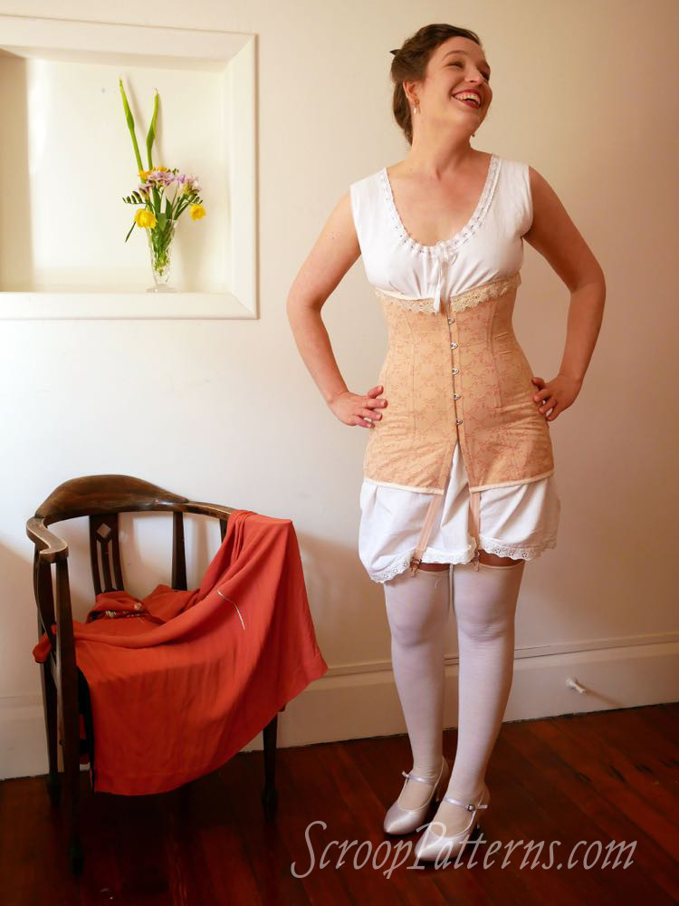 A model poses in a 20th century corset and ruffled r