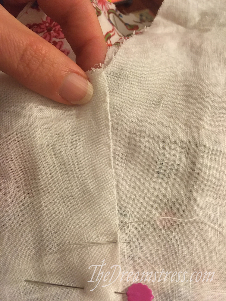 A whipstitched seam on a white linen lining