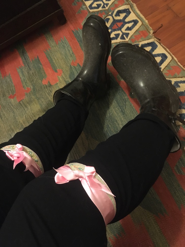 Image shows garters tied over black jeans, worn with gumboots