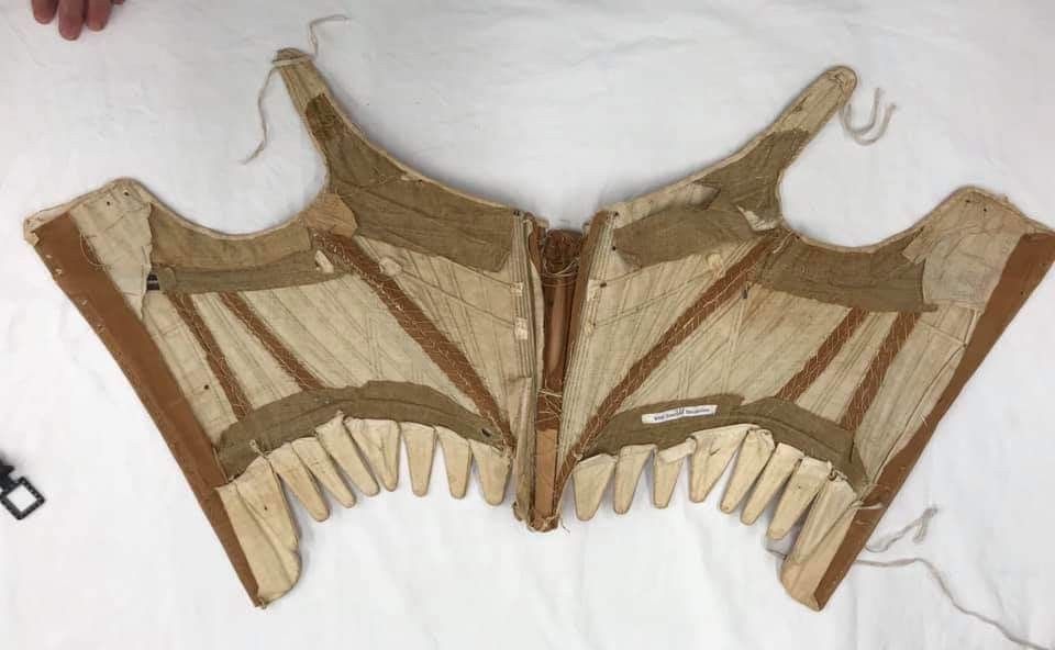 1780-1790. Brown twill linen half-boned stays w shoulder straps & 18 waist tabs, interlined with plain-weave linen, stiffened with whalebone, linen canvas, & wooden busk, University of New Hampshire Library 475